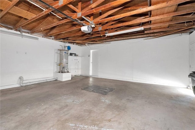 garage featuring strapped water heater and a garage door opener