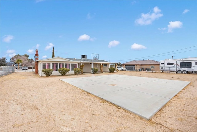 exterior space with central AC and basketball hoop