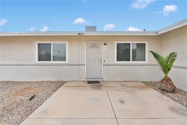 doorway to property with a patio area