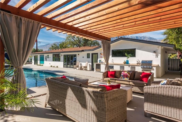 view of patio with area for grilling, outdoor lounge area, and a pergola