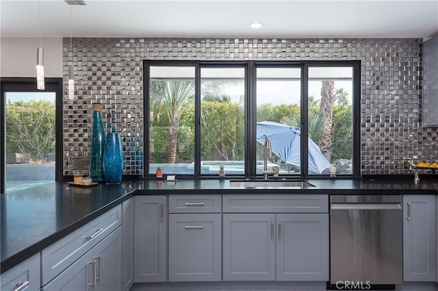 kitchen featuring gray cabinets, tasteful backsplash, dishwasher, sink, and hanging light fixtures