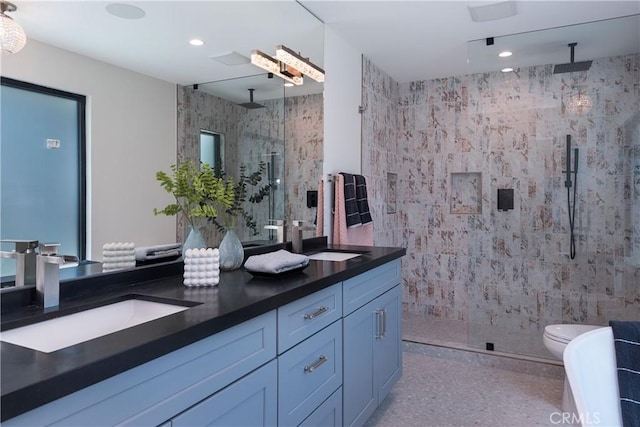 bathroom with vanity, tile walls, toilet, and a shower