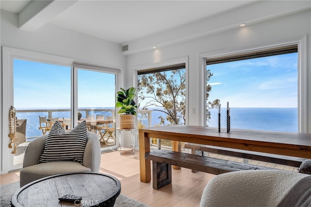 interior space featuring a water view and beamed ceiling