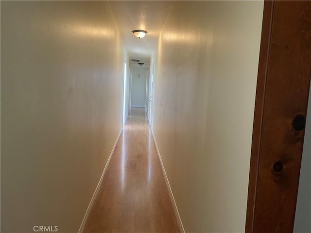 corridor featuring wood-type flooring