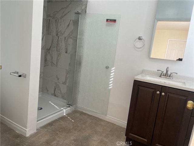 bathroom featuring vanity and tiled shower