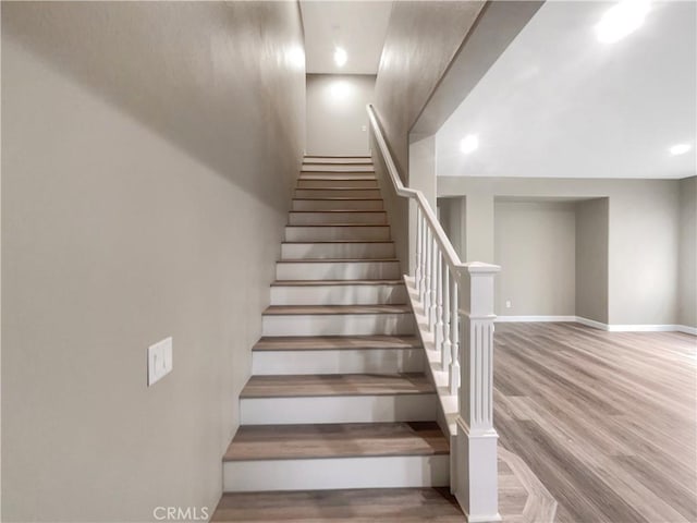 stairway featuring wood-type flooring