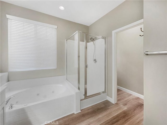 bathroom with hardwood / wood-style flooring and separate shower and tub