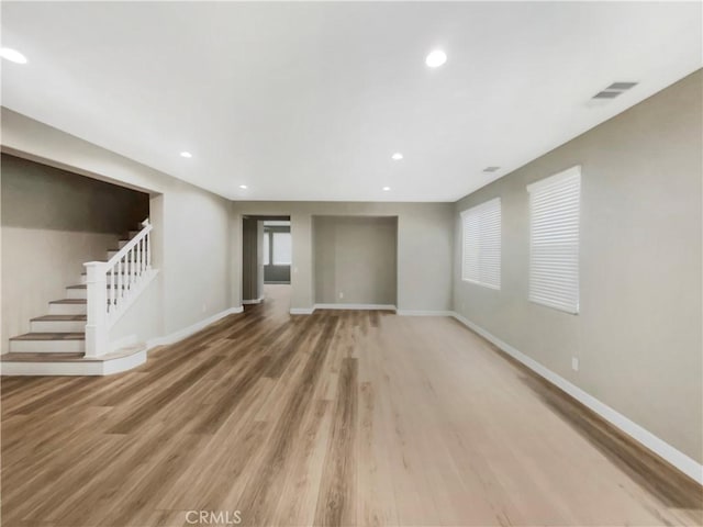 unfurnished living room featuring hardwood / wood-style flooring