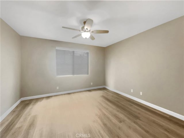 spare room with light hardwood / wood-style flooring and ceiling fan