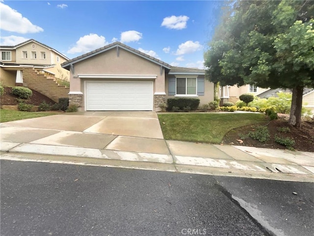 view of front of property with a garage and a front lawn