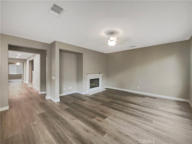 unfurnished living room featuring wood-type flooring