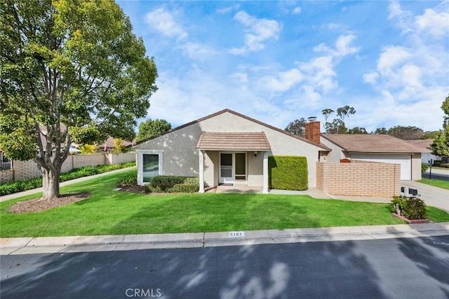 view of front of home with a front lawn and a garage