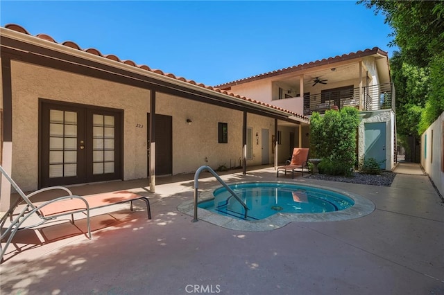 view of swimming pool featuring french doors and a patio