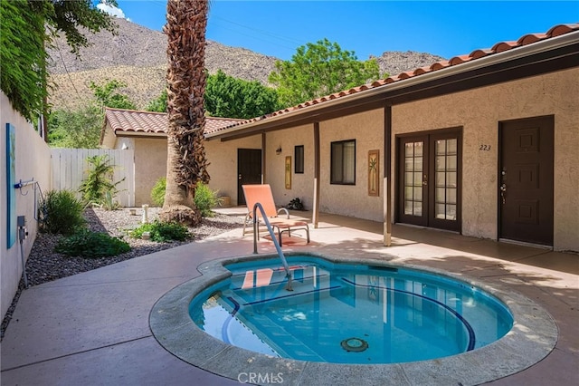 exterior space with a patio, a mountain view, and french doors