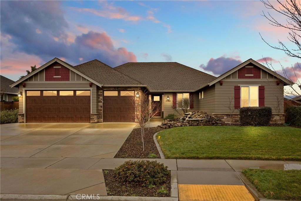 craftsman house with a garage and a yard