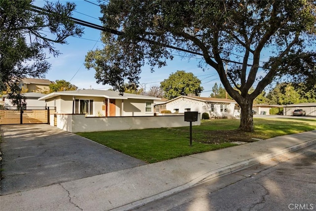 ranch-style house featuring stucco siding, fence, and a front yard