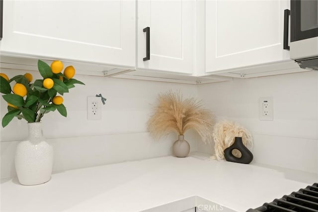 interior details with light countertops and white cabinets