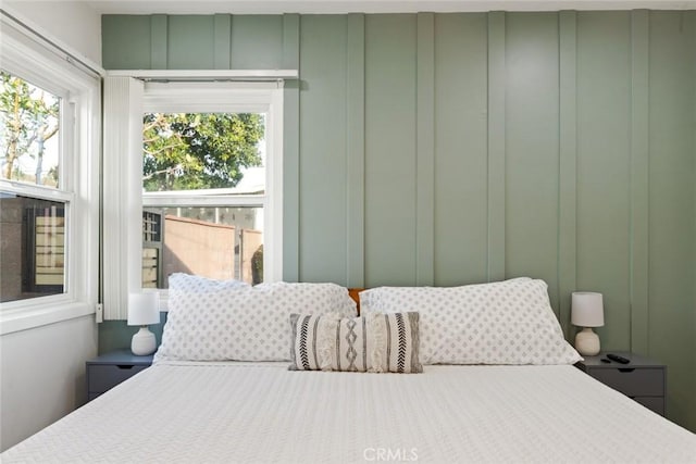 bedroom featuring a decorative wall