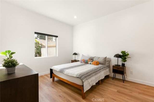 bedroom with light wood-style flooring, baseboards, and recessed lighting