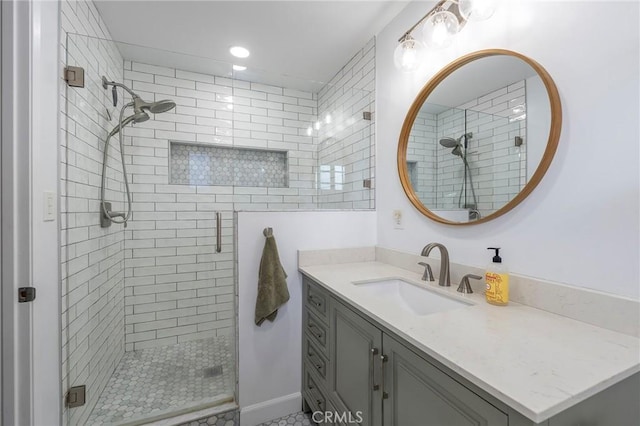 bathroom featuring vanity and a shower with shower door