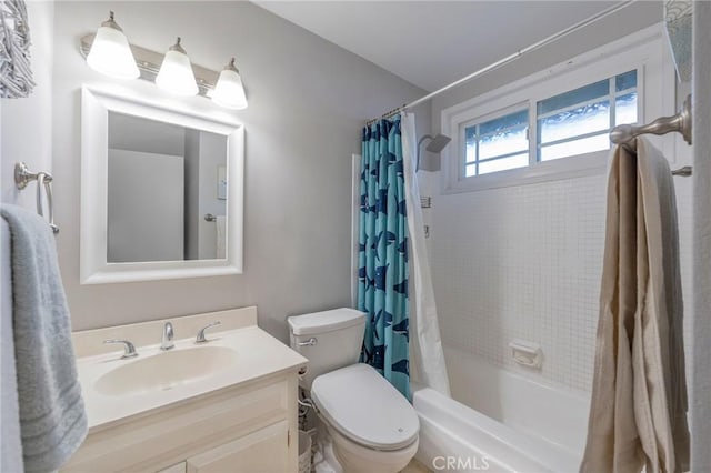 full bathroom with shower / tub combo with curtain, vanity, and toilet