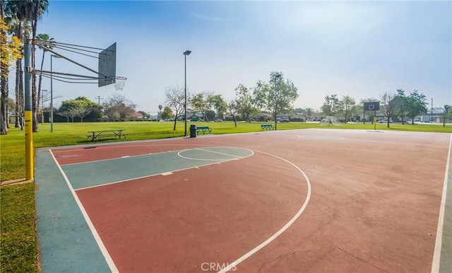 view of sport court featuring a lawn