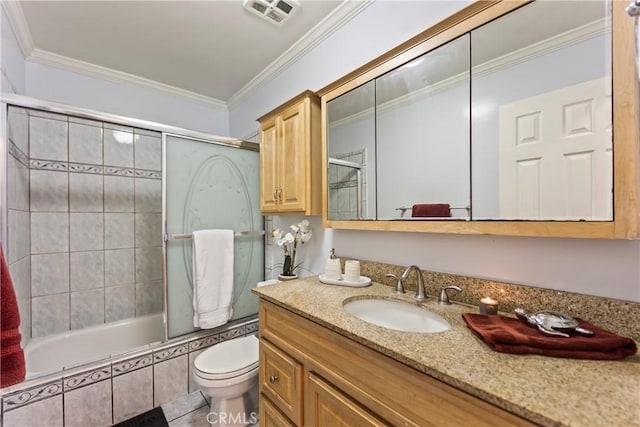 full bathroom featuring ornamental molding, vanity, tiled shower / bath combo, and toilet