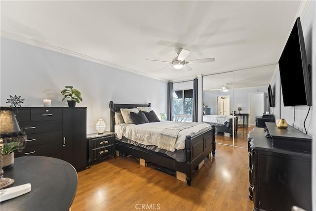 bedroom featuring hardwood / wood-style flooring, ceiling fan, and crown molding