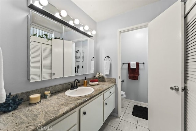 bathroom with tile patterned floors, toilet, and vanity