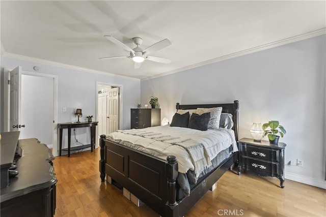 bedroom with hardwood / wood-style flooring, crown molding, and ceiling fan