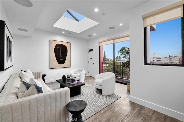 1304 N Mansfield Ave, Los Angeles, CA 90028 - living area featuring a skylight, wood finished floors, recessed lighting, and baseboards