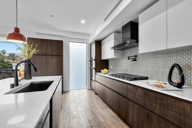 1304 N Mansfield Ave, Los Angeles, CA 90028 - kitchen featuring wall chimney exhaust hood, a sink, gas stovetop, modern cabinets, and recessed lighting