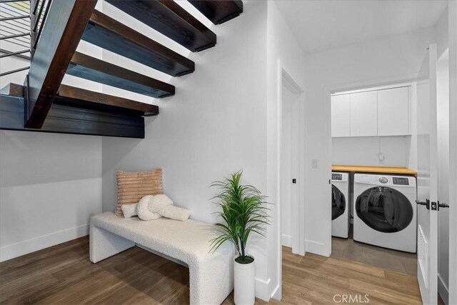 1304 N Mansfield Ave, Los Angeles, CA 90028 - laundry area featuring washer and clothes dryer, light wood-style floors, and baseboards
