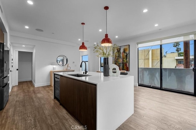 1304 N Mansfield Ave, Los Angeles, CA 90028 - kitchen featuring a sink, wood finished floors, baseboards, recessed lighting, and light countertops
