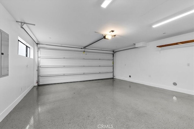 1304 N Mansfield Ave, Los Angeles, CA 90028 - garage featuring baseboards and a garage door opener