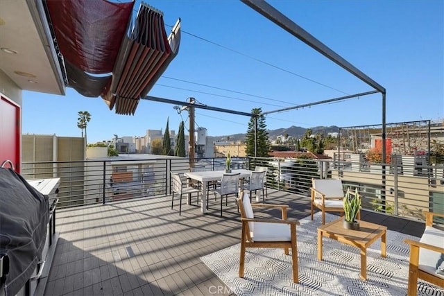 1304 N Mansfield Ave, Los Angeles, CA 90028 - view of patio featuring a balcony, a mountain view, outdoor dining area, and a grill