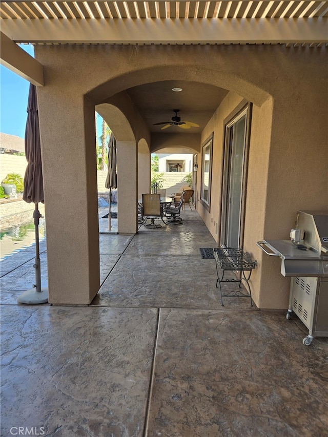 view of patio / terrace featuring ceiling fan and a pergola