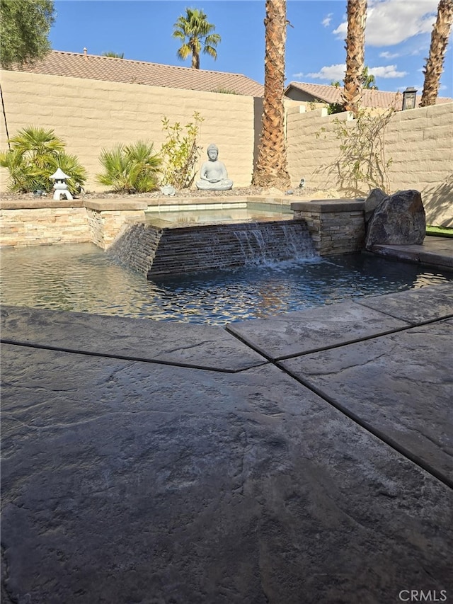 exterior space featuring pool water feature