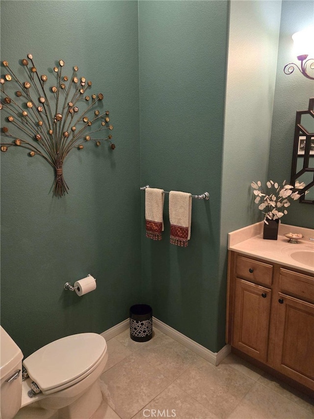 bathroom with tile patterned floors, vanity, and toilet