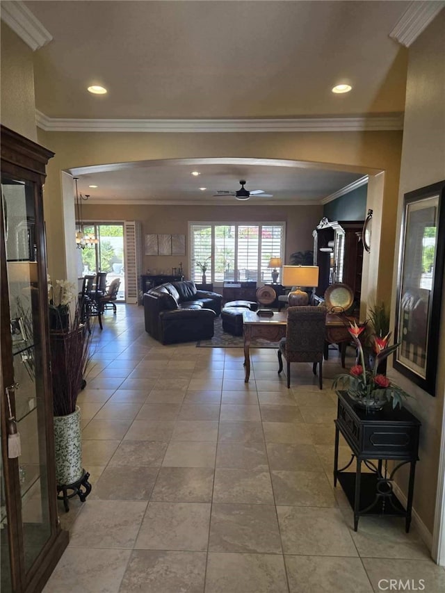 tiled living room featuring ceiling fan and ornamental molding