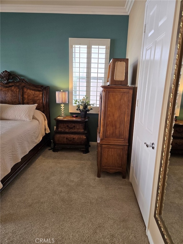 bedroom featuring crown molding and carpet flooring