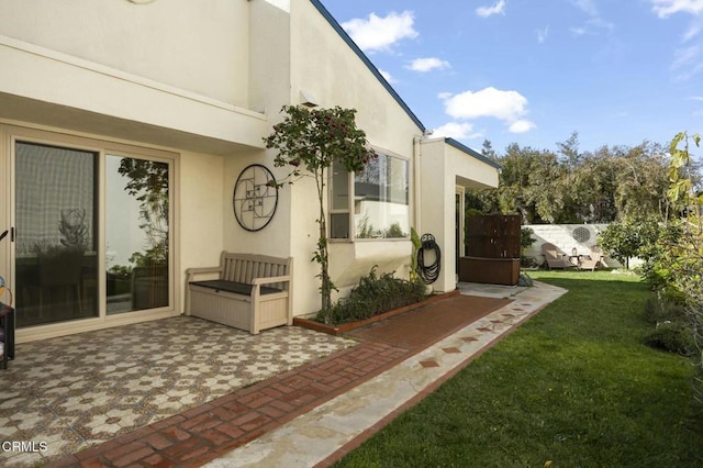 view of home's exterior featuring a lawn and a patio area