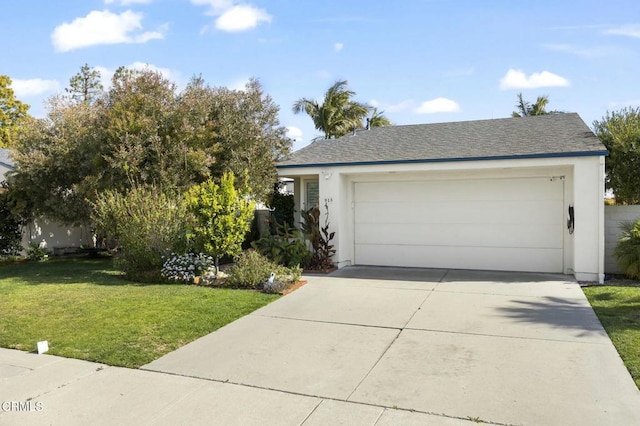 view of front of house with a garage and a front lawn