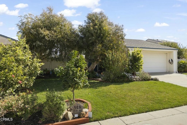 view of front of property with a garage and a front yard