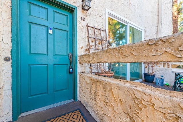 doorway to property with stucco siding