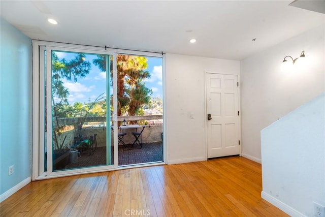 doorway featuring light hardwood / wood-style flooring and expansive windows