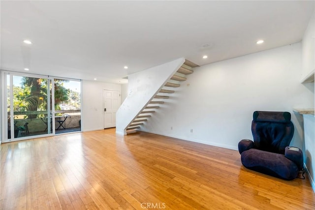 living room featuring light hardwood / wood-style floors and floor to ceiling windows