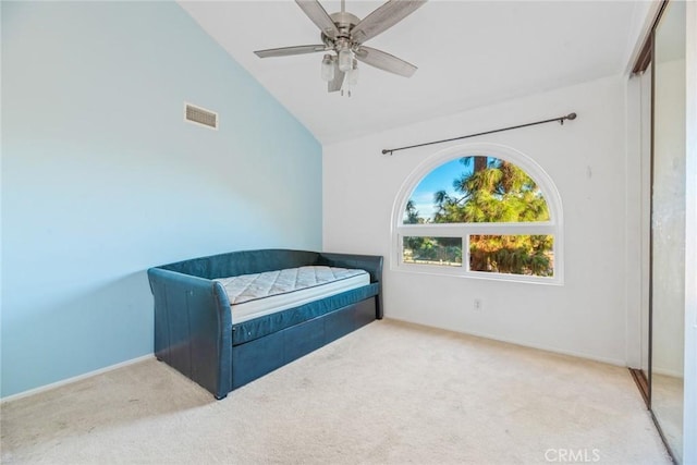 bedroom with vaulted ceiling, light carpet, and ceiling fan