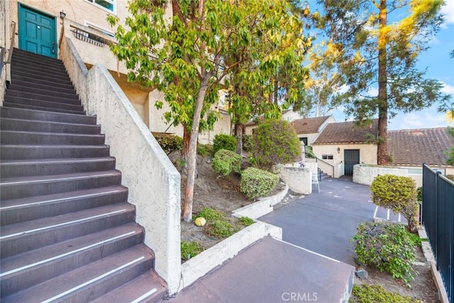 view of yard featuring stairs, a patio, and fence