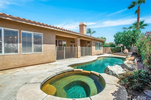 view of pool with a patio and an in ground hot tub